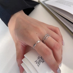 Detail of 925 sterling silver anchor chain rings worn on hand with lifestyle background