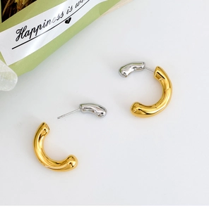 Detailed top view of U-shaped two-tone gold and silver minimalist titanium steel earrings