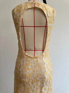 Detail of water-drop open back design on yellow floral lace bodycon maxi dress