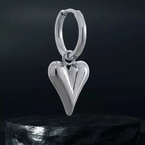Vue détaillée du pendentif cœur 3D poli sur créole argentée avec finition miroir