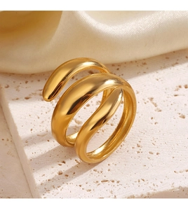 Macro shot of gold-plated spiral ring detail on white stone with luxury silk background