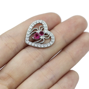 Silver heart belly button ring with a red gemstone spider pendant for body piercing