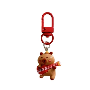 Cute Capybara keychain with red ukulele and matching metal D-ring hook for bags