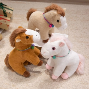 Cute plush pony toys with bells in brown and white on a soft rug with gift box decor
