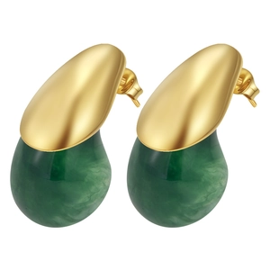 Detail of gold-plated stainless steel and green marbled resin teardrop stud earrings