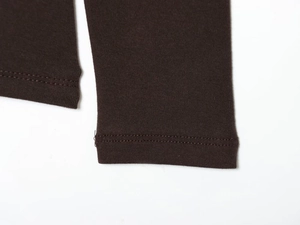 Macro view of dark brown knitted t-shirt with durable double-needle stitching detail