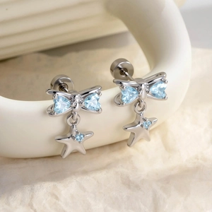 Silver bow and star cartilage earrings with blue heart stones and screw back closure