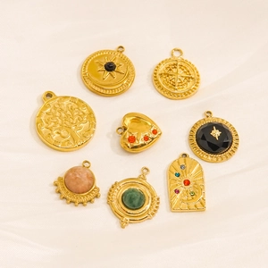 Bohemian gold pendants with colorful natural stones and engravings on white silk