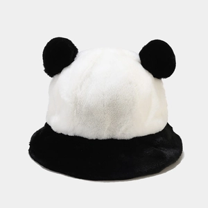 Close-up of plush panda bucket hat featuring soft faux fur texture and black pom-pom ears