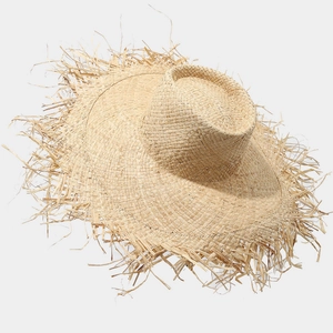 Summer raffia sun hat with oversized frayed brim and natural straw texture for beach vacation