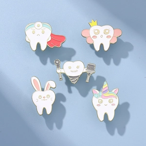 Set of 5 unique tooth-themed metal enamel pins in cute cartoon medical dental designs