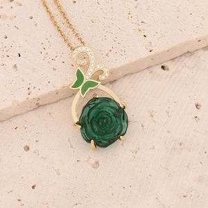 Gold stainless steel necklace with green rose pendant and butterfly accent on stone