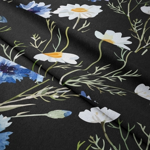 Close-up of bohemian wall tapestry showing white daisies and blue flowers on black fabric