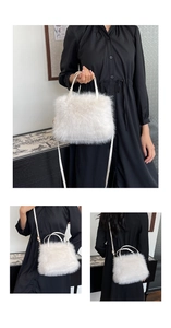 Detail of white faux fox fur crossbody bag with fluffy texture and gold hardware straps