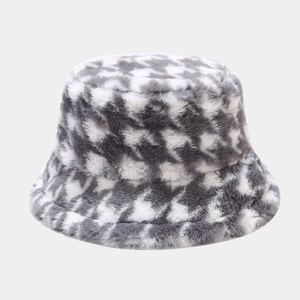 Detailed close-up of grey and white houndstooth pattern on soft plush winter bucket hat