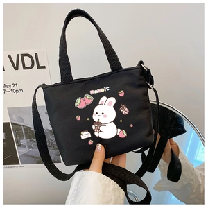 Detail of black canvas bag with cute cartoon rabbit print and strawberry milk tea pattern