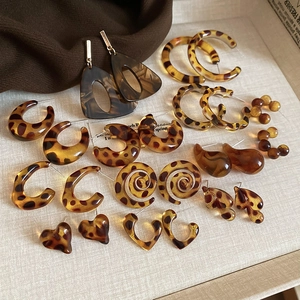 Flat lay of retro leopard print resin earrings in tortoiseshell colors and various shapes