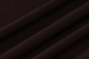 Macro shot of dark brown knit fabric texture showing the premium weave and soft drape