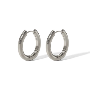 Close-up of polished silver stainless steel chunky hoop earrings with hinge closure