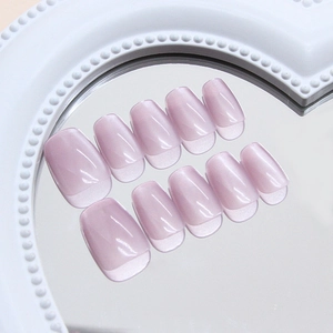 Light purple cat-eye press-on nails with French tips on a white heart pearl mirror