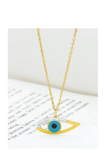 Detailed close-up of golden Evil Eye pendant featuring blue stones and sparkling rhinestones