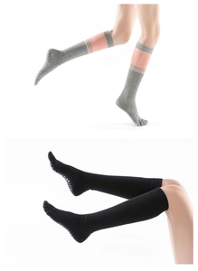 Detail of over-the-knee five-finger yoga socks with anti-slip grips on the soles