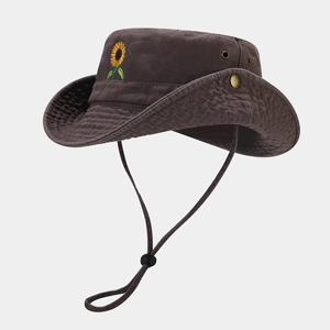 Detailed view of sunflower embroidery, metal eyelets and windproof cord on a canvas sun hat