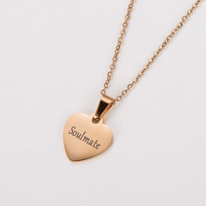 Macro detail of rose gold heart pendant with soulmate engraving and delicate chain