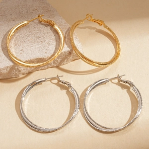 Classic 18k gold and silver plated double-layer layered hoop earrings on stone background