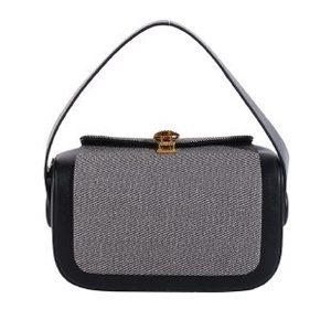 Chic black leather and gray fabric box bag with gold metal clasp on white background