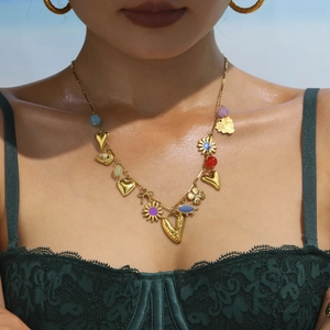 Summer 18k gold necklace featuring heart and sun flower charms on a female model