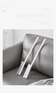 Detail view of a long-handle nylon crevice brush for cleaning furniture and radiator gaps