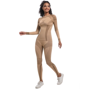 Detail showing seamless knit texture and compression stripes on a two-piece yoga set