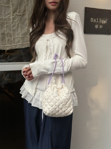 Outdoor lifestyle view of a quilted drawstring bag with floral patterns and purple handles