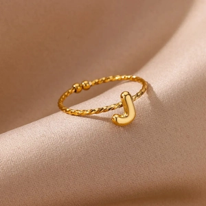 Macro shot of 18k gold plated letter J ring with twisted rope band detail