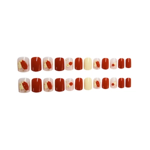 Elegant red and white press-on nails set with gold foil accents and glossy finish
