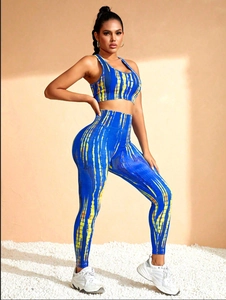 Detail of seamless yoga set with blue and yellow tie-dye pattern on breathable fabric