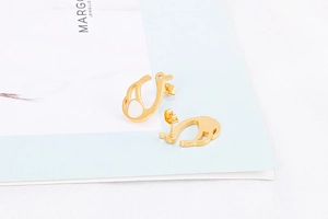 Macro detail of golden swan stud earrings with clear crystal inlay and butterfly clasp