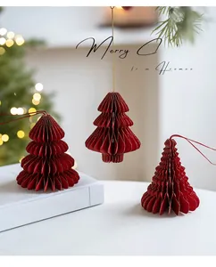 Macro shot of red paper honeycomb Christmas tree ornament with glitter edges and gold accents