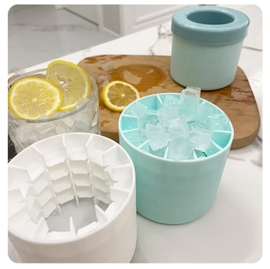 Detail of light blue cylindrical silicone ice mold with internal grids on marble surface