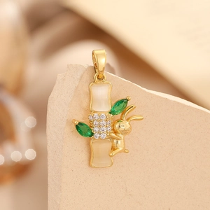 Macro view of a bamboo and rabbit pendant with opal stones and green crystals