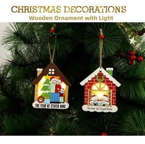 Macro detail of lighted wooden house ornament with The Year We Stayed Home slogan