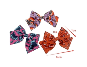 Rugby print bow hair clips in purple, blue and orange showing 14cm width and 15g weight