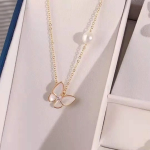 Elegant butterfly necklace with freshwater pearl and gold chain in a jewelry box