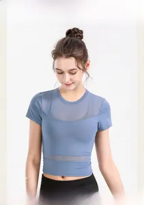 Detail of blue cropped yoga top featuring breathable mesh panels and fitted short sleeves