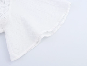 Detailed macro of white crinkled fabric with elegant lace stitching and texture