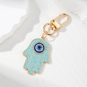 Vintage Hamsa Hand and Evil Eye keychain with blue enamel and sparkling rhinestones