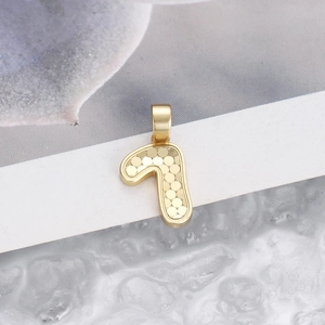 Detailed close-up of a gold-finish number 7 pendant with inner circular scale texture