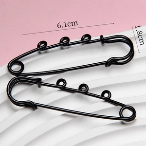 Macro view of 6.1cm black multi-loop safety pin showing precise dimensions and glossy finish
