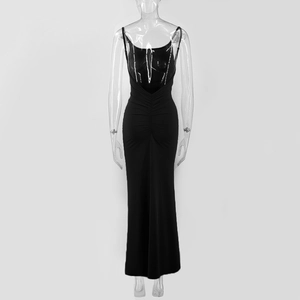 Rear view of black backless maxi dress with elegant waist ruching and sleek drape